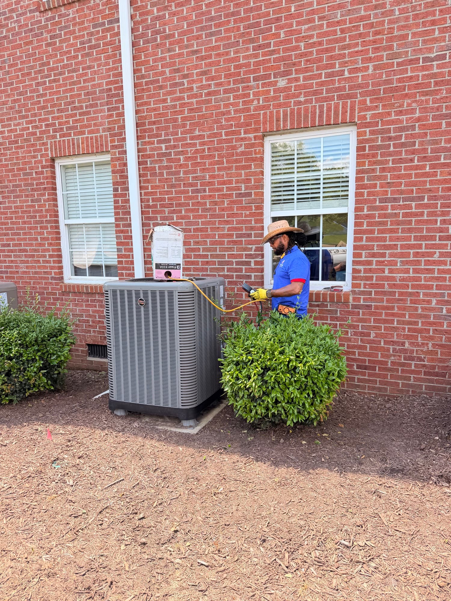 Restore technician checking a residential outdoor HVAC unit